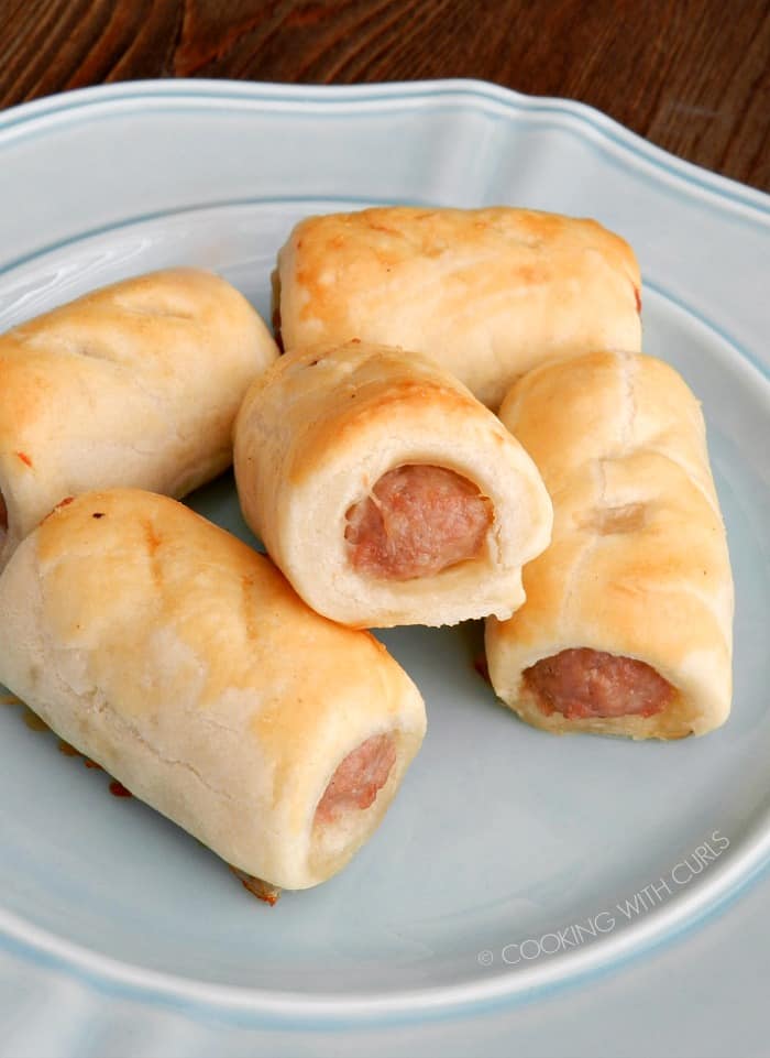 A stack of Turkey Sausage Rolls piled up on a blue plate