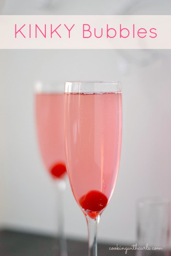 Kinky Bubbles Cocktail in a champagne flute with a cherry at the bottom