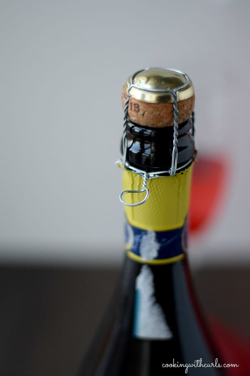 Close-up image of the metal cage at the top of a Prosecco bottle.