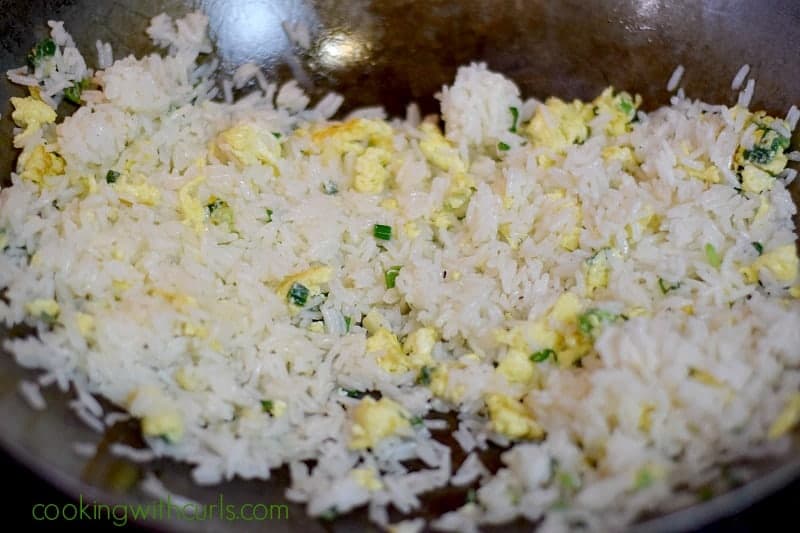 Scrambled eggs mixed with white rice in a wok.