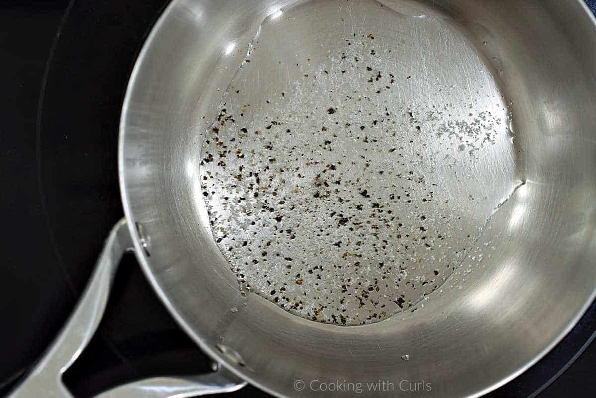 Oil, salt and pepper in a saucepan.