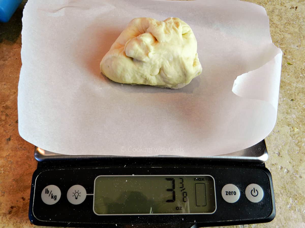 Ball of dough on a digital kitchen scale.