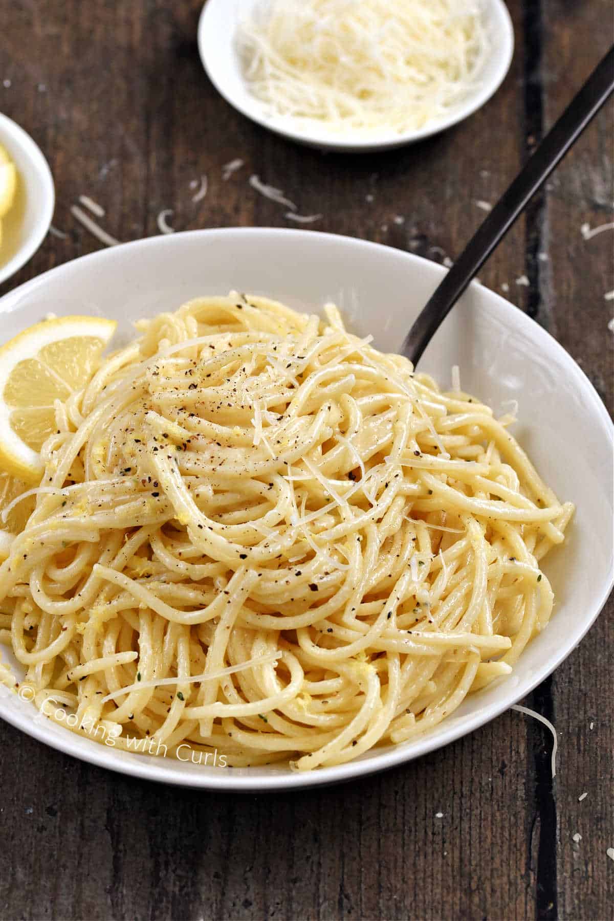 Spaghetti al Limone with black pepepr and lemon zest in a bowl.