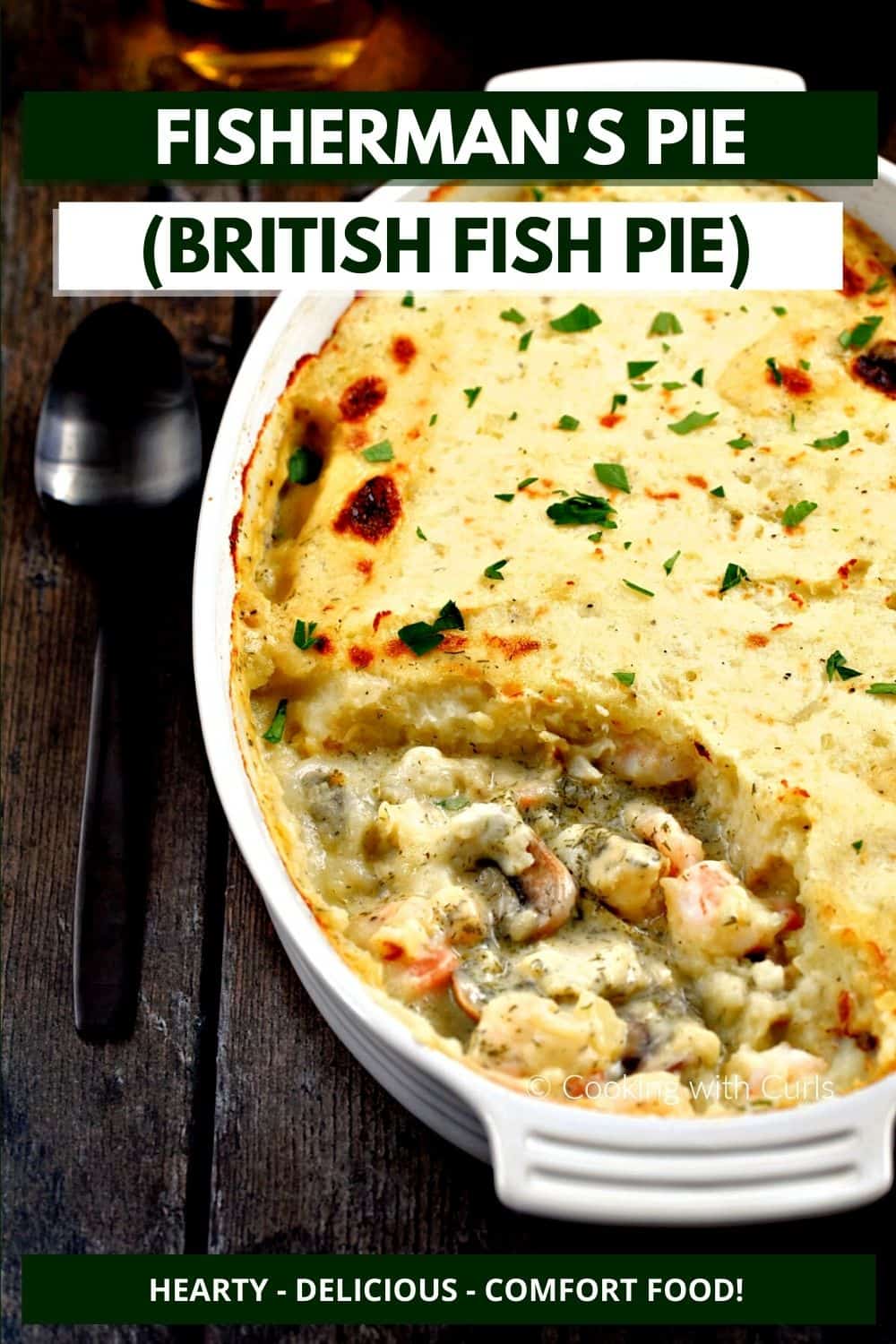 Mashed potato topped fish pie in an oval baking dish with the front quarter of the ingredients removed and title graphic across the top.