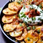 Thinly sliced potatoes arranged in a cast iron skillet topped with melted cheese, bacon, sour cream, salsa and green onions with title graphic across the top.