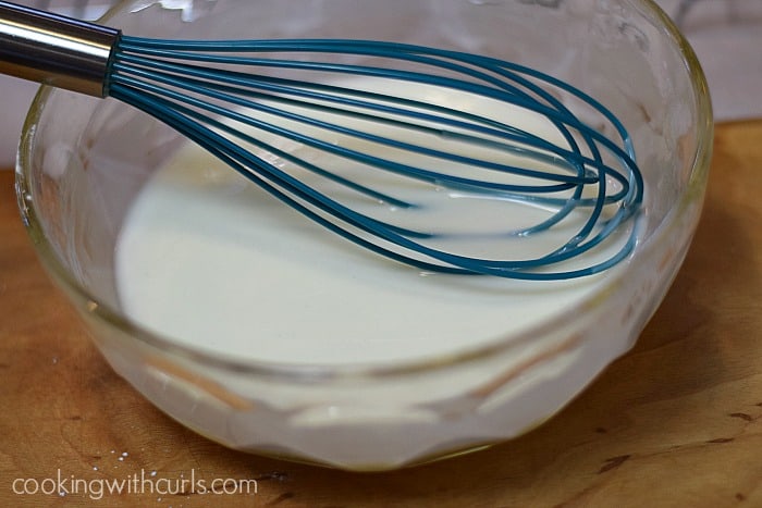 Glaze mixed together with a whisk in a large mixing bowl.