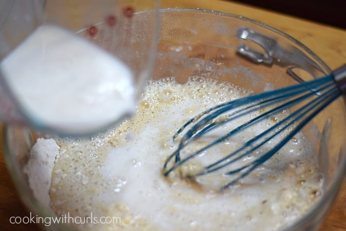 Flour and milk whisked together in a large glass bowl.