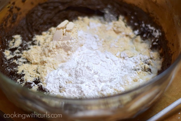 flour added to the chocolate mixture in a large glass bowl