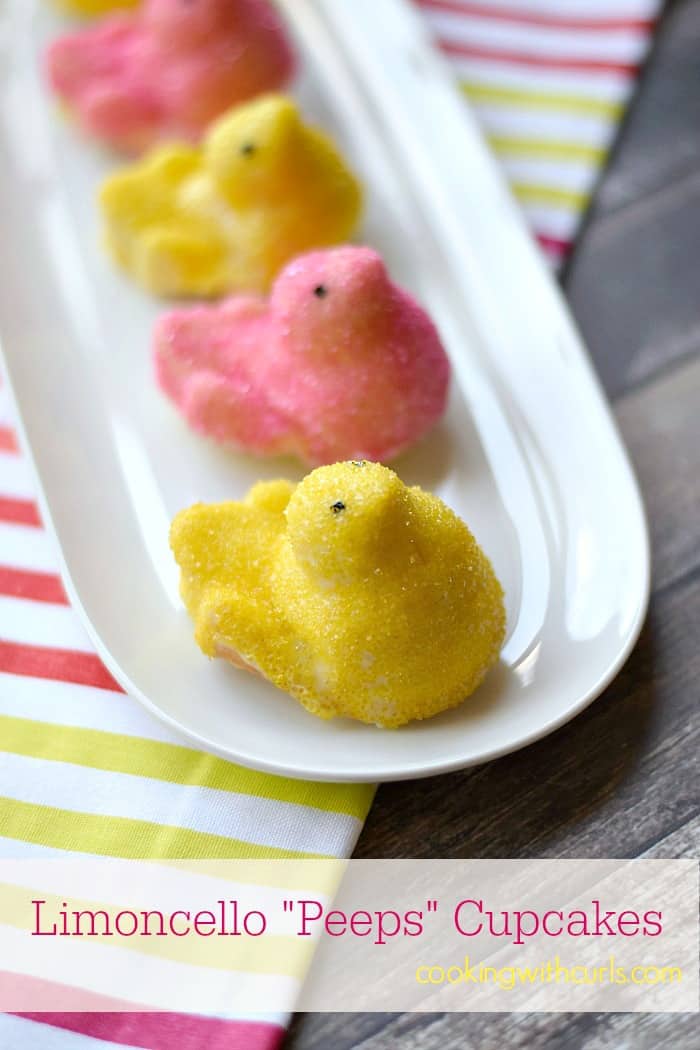 pink and yellow sprinkle covered chicks on an oval platter sitting on a pink, yellow and white striped napkin