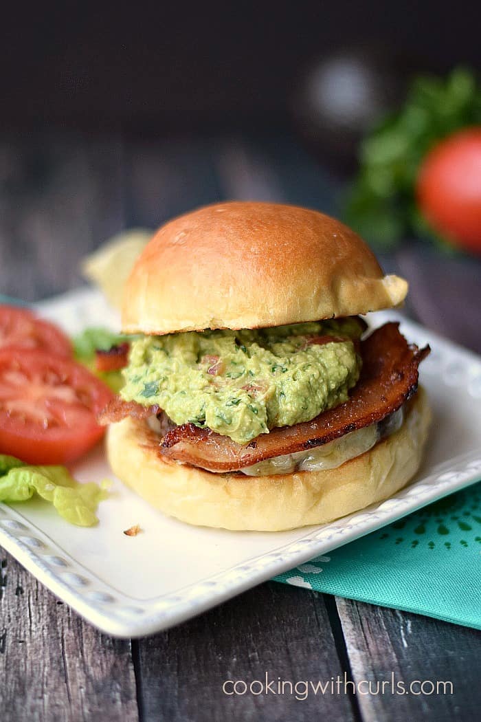 These yummy California Burgers are topped with melted cheese, homemade guacamole and sandwiched between toasted buns! cookingwithcurls.com