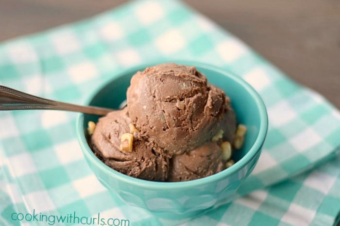 Vegan Chocolate Walnut Fudge Ice Cream in a small turquoise bowl sitting on a turquoise and white checkered napkin.
