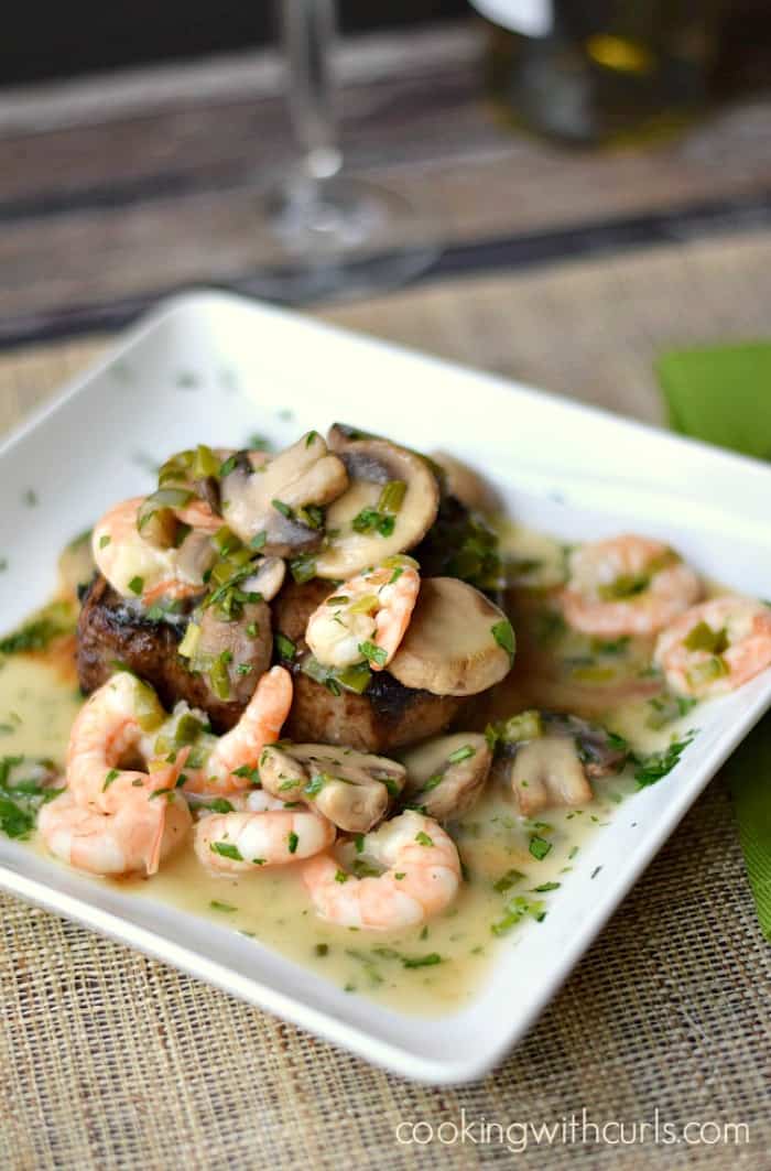 Beef Tenderloin with Shrimp and Mushroom Sauce on a square white plate