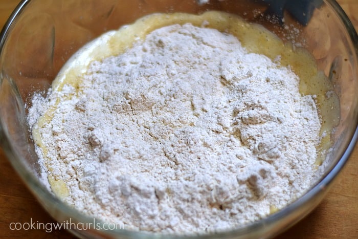 Flour, baking powder, baking soda, and salt added to the liquid ingredients.