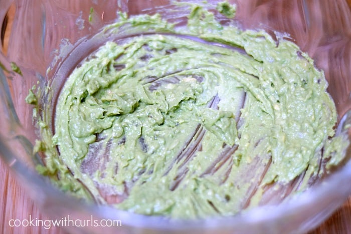 Mashed avocado in a large mixing bowl.