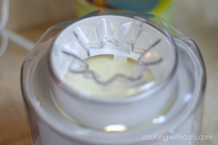 Ice cream churning in a white ice cream maker.