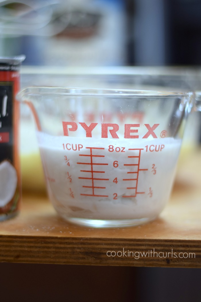 One cup of coconut cream in a glass measuring cup.