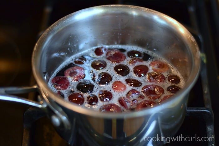 cherry syrup simmering in a saucepan.