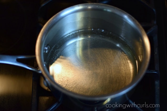 sugar dissolved in water simmering in a saucepan.
