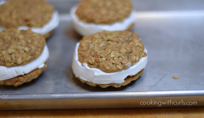 Four ice cream sandwiches on a baking sheet.