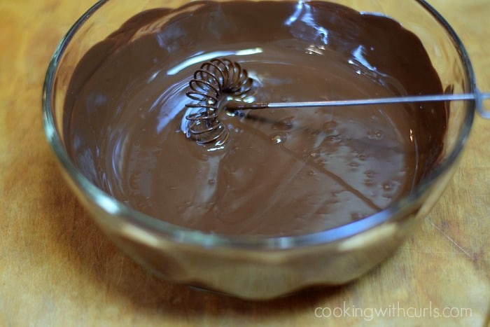 Melted chocolate and oil whisked together in a large bowl.