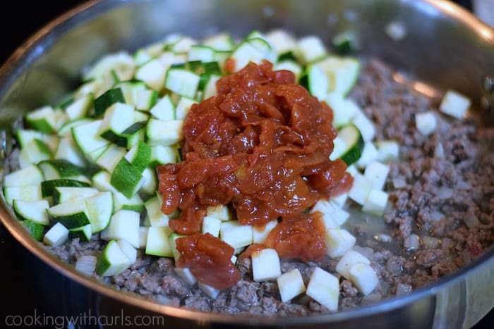 Diced zucchini, eggplant, and tomatoes added to the meat mixture.