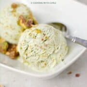 Pistachio Ice Cream topped with Pistachio Praline in a white rectangle dish with a spoon on the side and title graphic across the top.