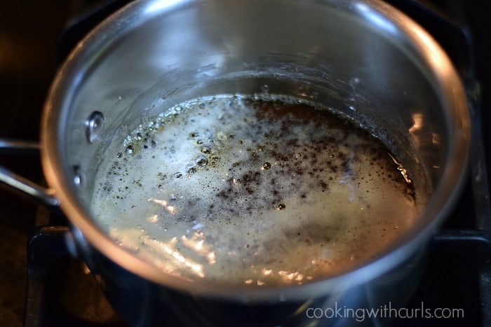 Simmering water and sugar mixture in a saucepan.
