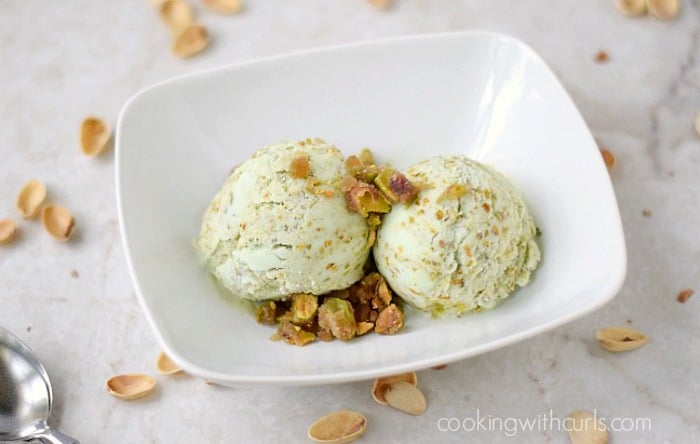 Two scoops of Pistachio Ice Cream with Pistachio Praline in a white bowl.