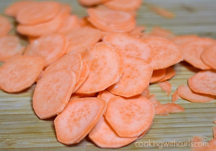 Raw sweet potato slices on a cutting board