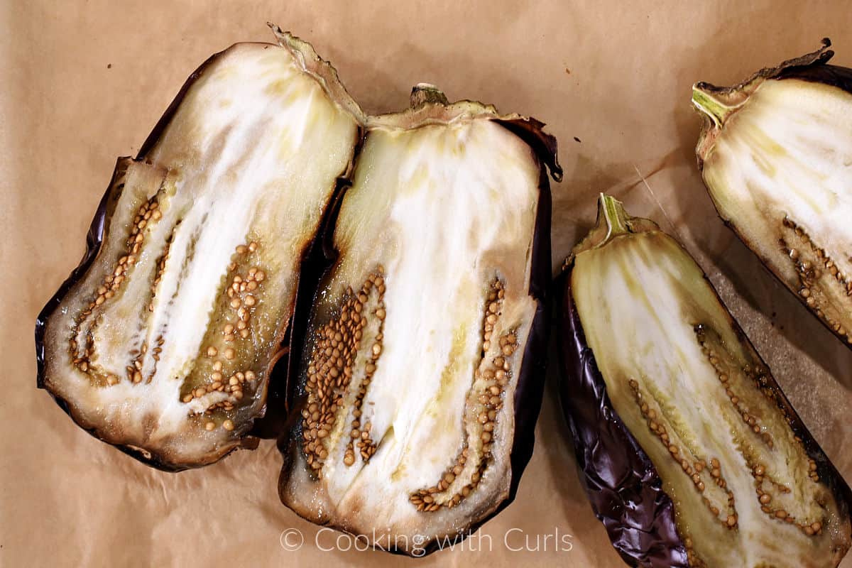 Two large, roasted eggplants sliced in half. 