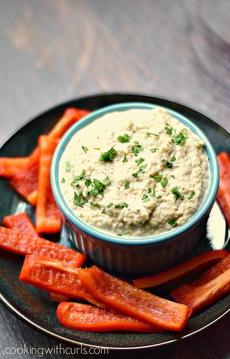 Yummy Greek Eggplant Dip {Melitzanosalata} on a plate with red bell pepper strips