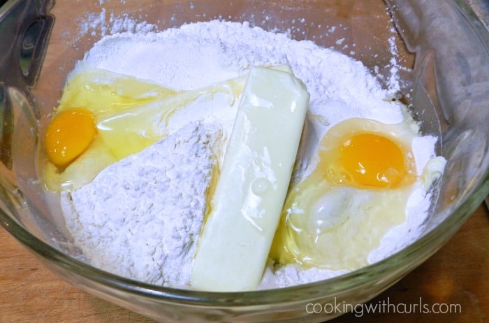Flour, butter, and eggs in a large mixing bowl.