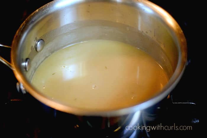 beef gravy simmering in a saucepan. 
