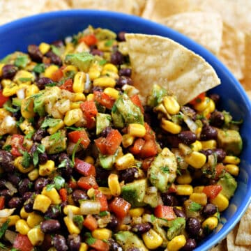 Black bean and corn salsa in a serving bowl with tortilla chips.