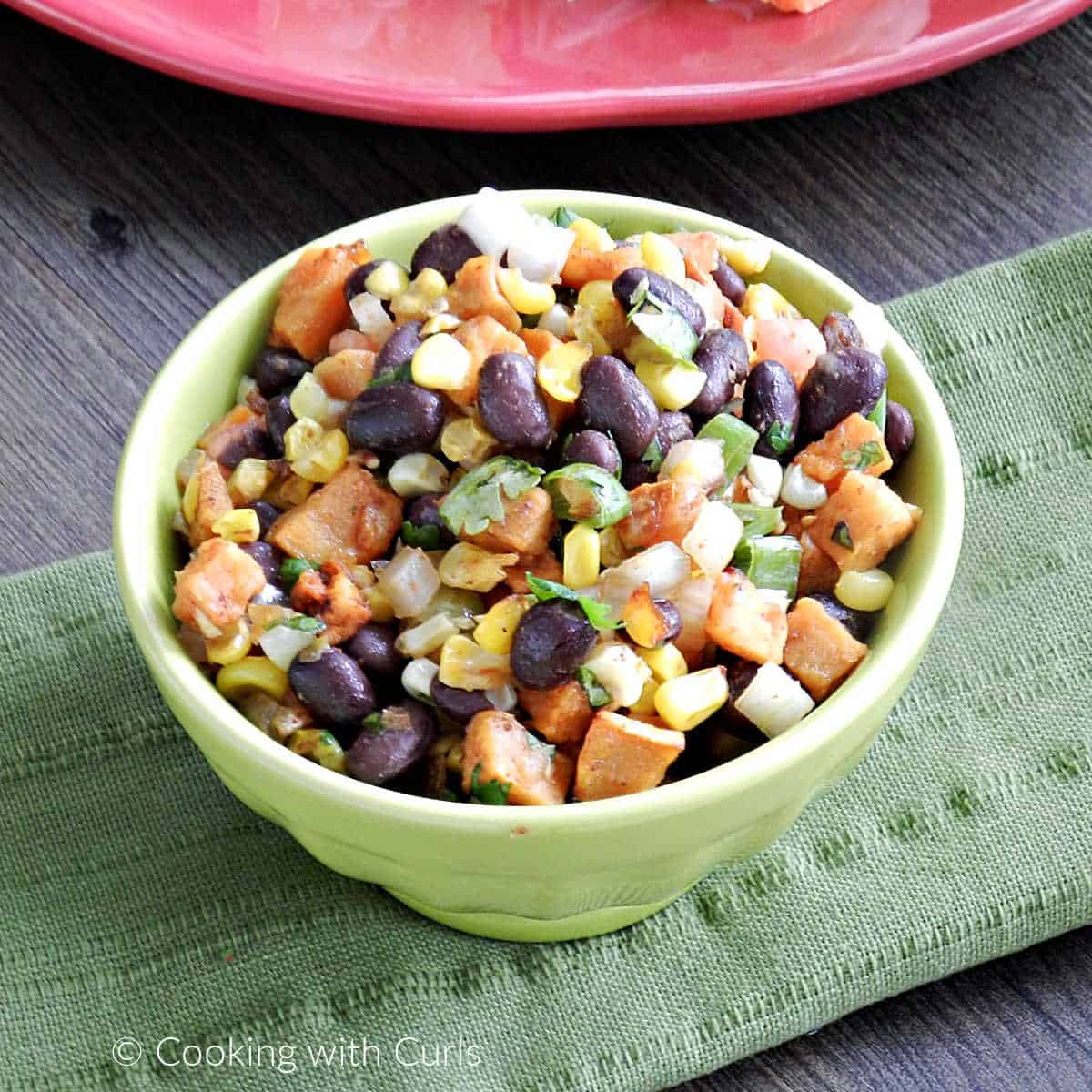 Black bean salsa with roasted corn and sweet potato in a small bowl.