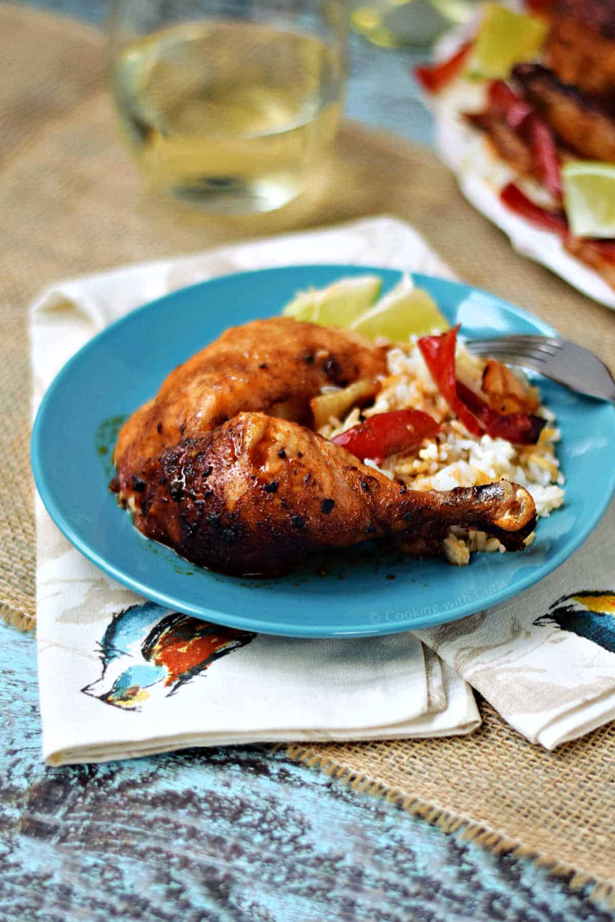 Roast chicken legs on a bed of rice.