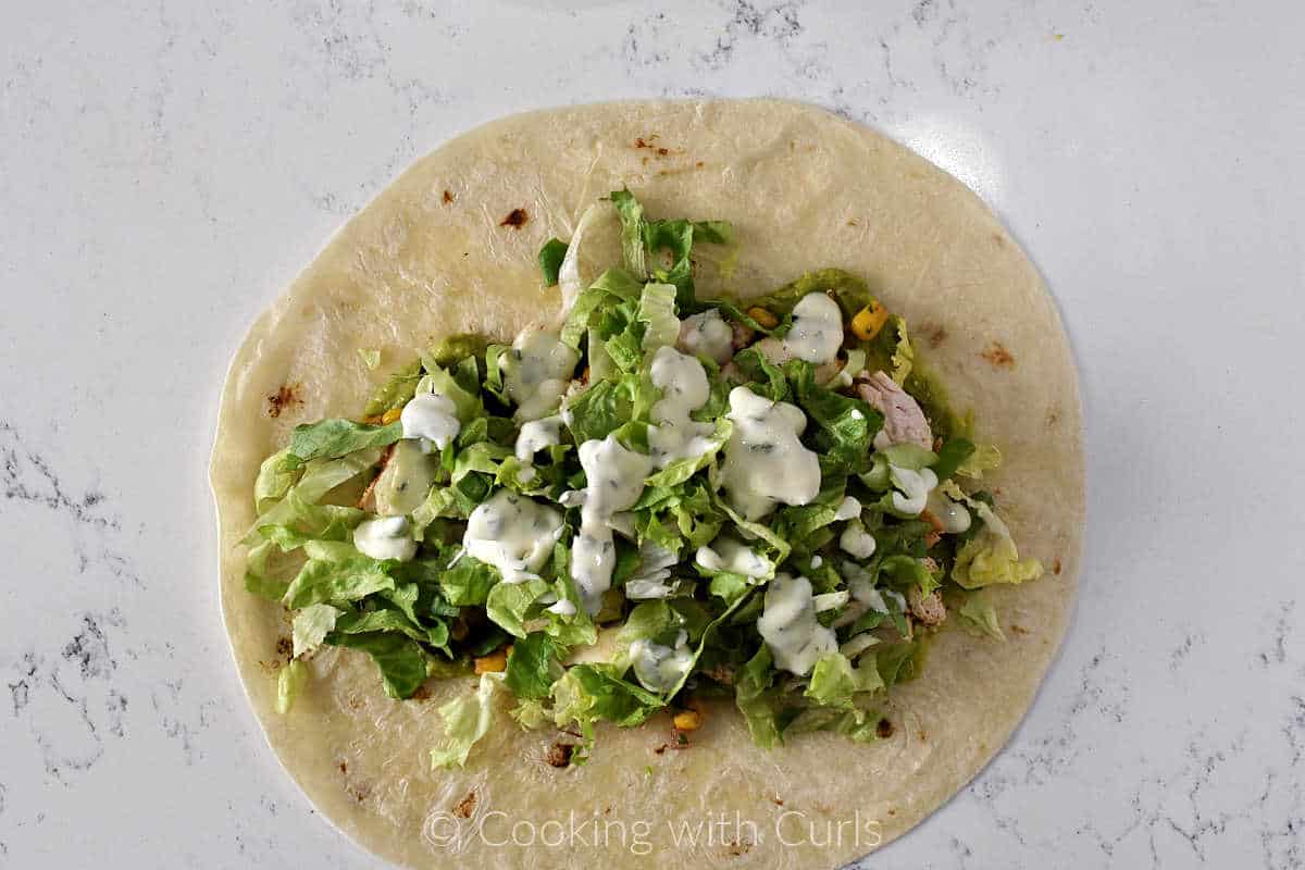 Southwest-Chicken-Wrap-lettuce-and-ranch-dressing-on-large-tortilla.