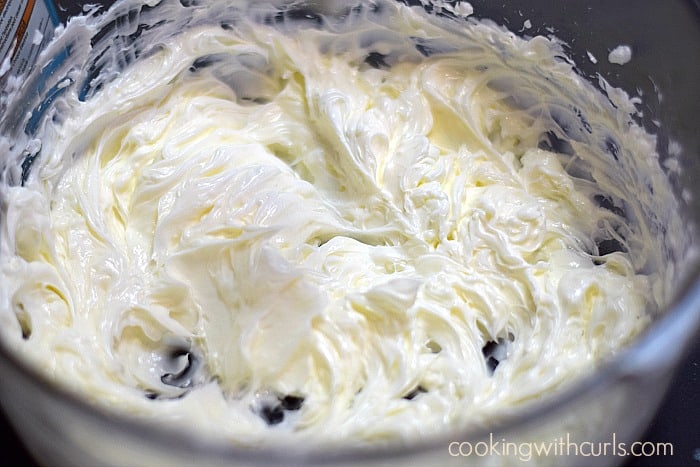 Buttercream frosting mixed together in a large bowl.