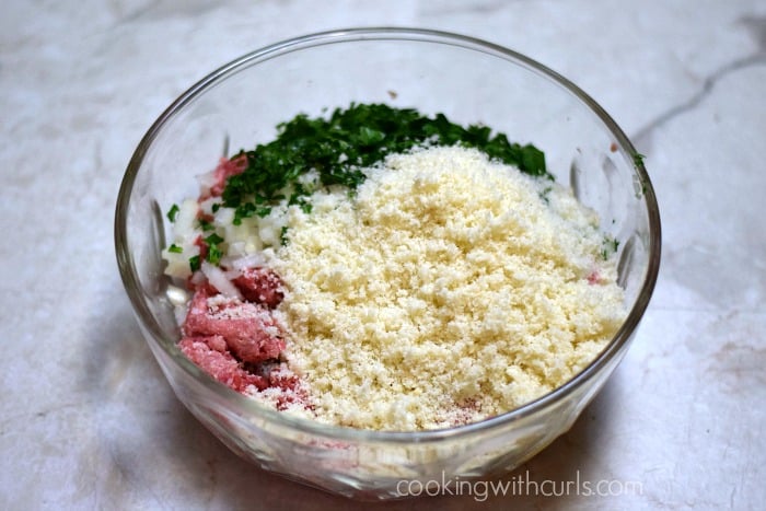 Ground meats, parsley, bread crumbs, and eggs in a large bowl.
