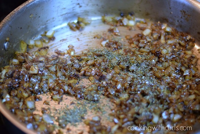 Brown sugar and thyme added to the caramelized onions in a large skillet.