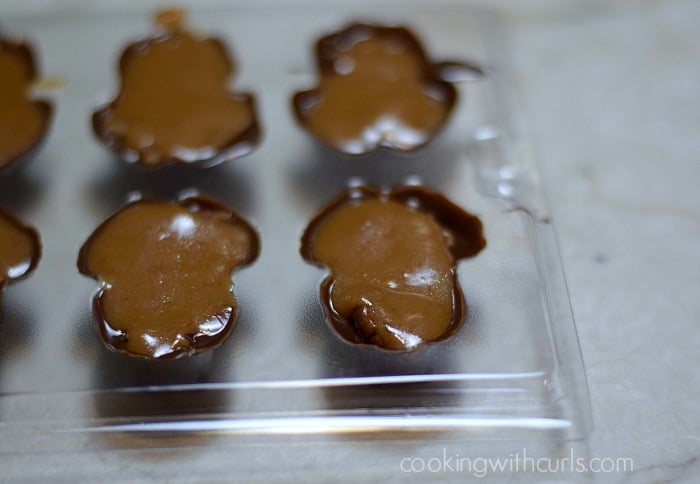Caramel added over the top of the pecans in the frog mold.