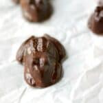 chocolate frogs laying on white parchment paper