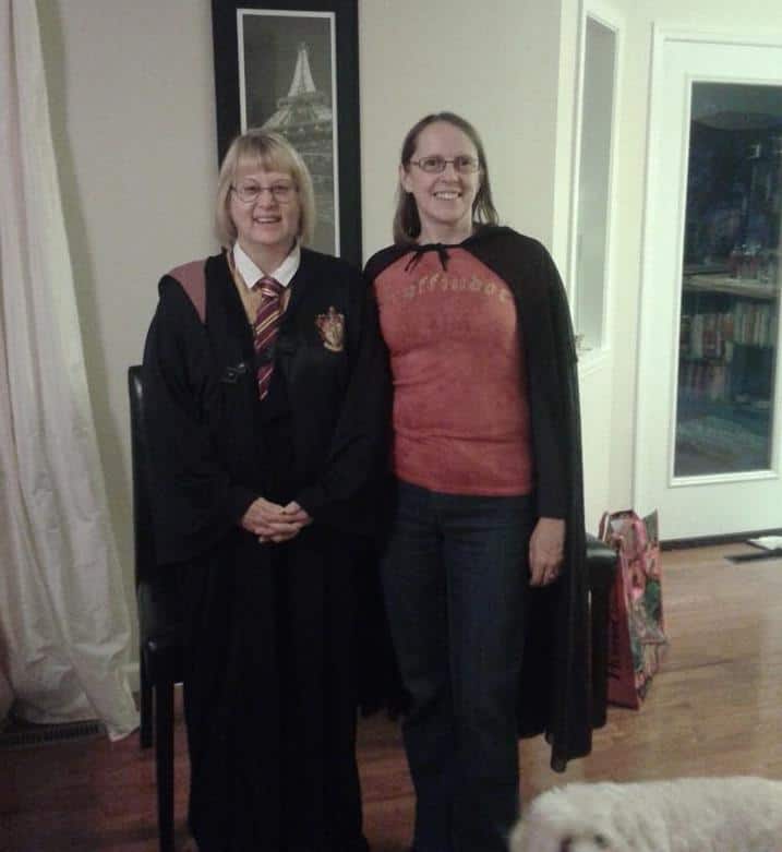 Two women dressed as Gryffindor wizzards.