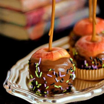 Halloween decorated Caramel Apples on a silver tray. 