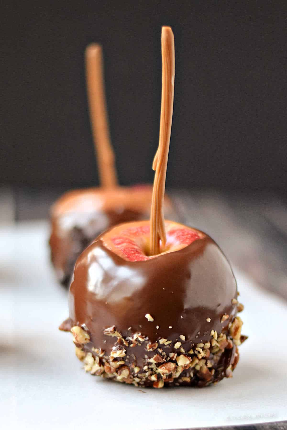 Homemade caramel apple with chopped nuts.