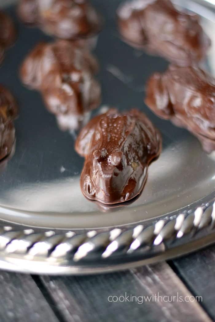 Seven chocolate frogs on a silver serving platter.