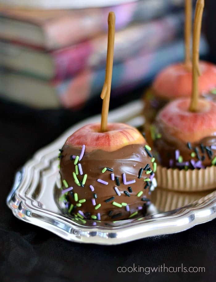 Three Caramel Apples on a silver tray with Harry Potter books in the background