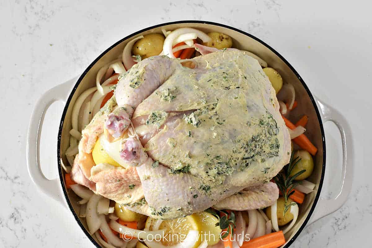 herb-butter-rubbed-chicken-on-top-of-vegetables-in-a-cast-iron-skillet.