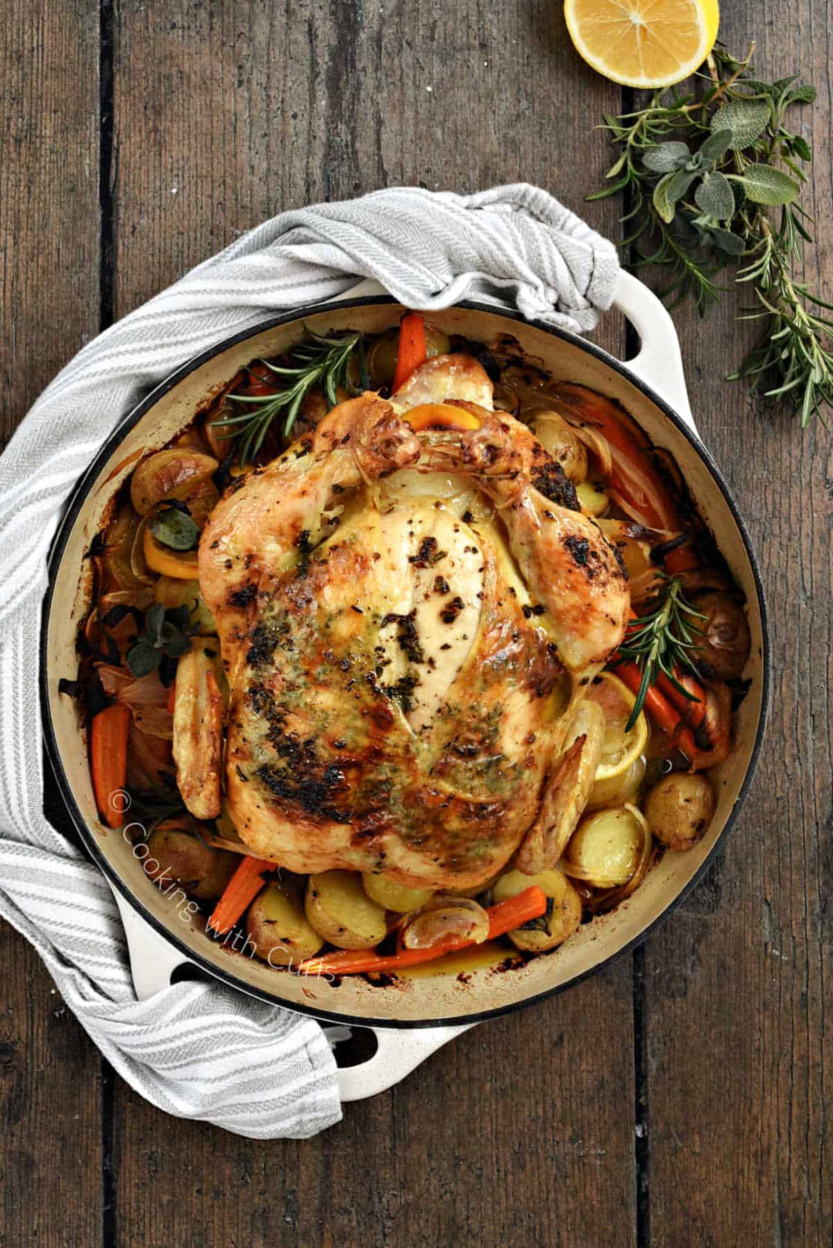 simple-roast-chicken-on-potatoes-and-carrots-in-a-cast-iron-skillet.