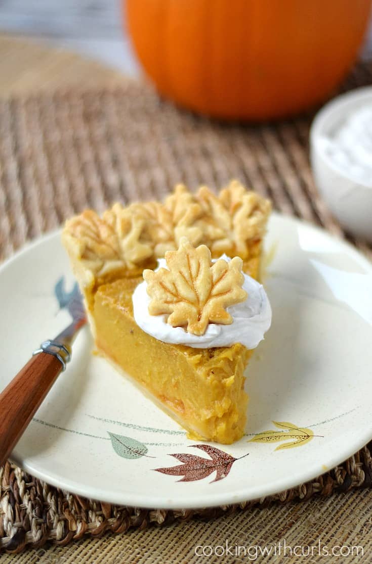 A slice of delicious Dairy-free Pumpkin Pie topped with coconut whipped cream | cookingwithcurls.com
